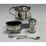 A George V silver three-piece condiment set, comprising oval salt with blue glass liner, oval