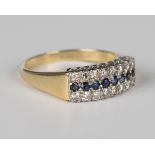 An 18ct gold ring, mounted with a row of eight circular cut sapphires between two rows of eight