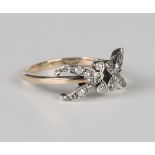 A gold, silver and diamond ring in a stylized foliate design, mounted with cushion cut diamonds,