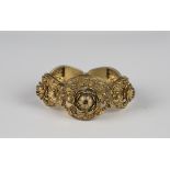 A silver gilt filigree bracelet in a curved oval panel shaped design, decorated with floral