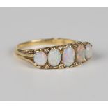 An 18ct gold, opal and diamond ring, mounted with five oval opals graduating in size to the