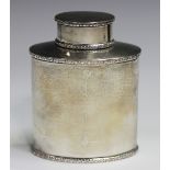 A George V silver oval tea caddy and cover, decorated in relief with foliate bands, Birmingham