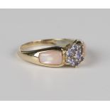 A 9ct gold, tanzanite and pink stained mother-of-pearl cluster dress ring, decorated with mother-