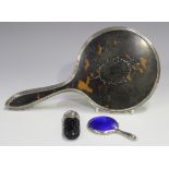 A George V silver and tortoiseshell dressing table hand mirror, Birmingham 1923, length 26cm,