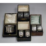 A pair of Edwardian silver napkin rings, pierced and engraved with foliate bands, Birmingham 1902