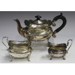 An Edwardian silver three-piece tea set, comprising teapot, milk jug and sugar bowl, each of cushion