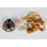 Twenty-one varicoloured mottled opaque butterscotch coloured loose amber beads, gross weight 17.