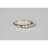 A gold, platinum and diamond five stone ring, claw set with a row of graduated cushion cut diamonds,