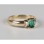 A 9ct two colour gold and synthetic green gem set solitaire ring, import mark London 1998, weight