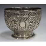 A late 19th century Burmese silver rose bowl, the body decorated in relief with a band of arched