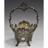 A German .800 silver sugar basket, the overhead scroll swing handle above a pierced and embossed