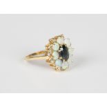 A gold, sapphire, opal and diamond oval cluster ring, claw set with the oval cut sapphire within a