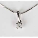 A white gold and diamond single stone pendant, claw set with a circular cut diamond, detailed '375',
