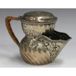 An Edwardian silver shaving mug, the spiral fluted body decorated with foliate scrolls, the spout