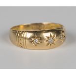 A late Victorian 18ct gold ring, star gypsy set with three cushion cut diamonds between decorated