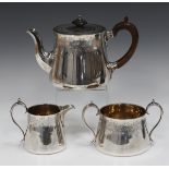 A late Victorian and later silver three-piece tea set, comprising teapot, milk jug and two-handled