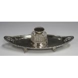 A late Victorian silver boat shaped inkstand with pierced and engraved foliate decoration within a