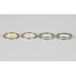 Two diamond half-hoop eternity rings, each mounted with a row of twelve cushion cut diamonds, a