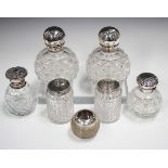 A pair of late Victorian silver screw-topped hobnail cut glass scent bottles, London 1884, height