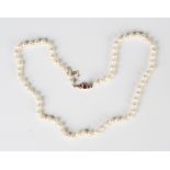 A single row necklace of baroque cultured pearls on a gold, ruby and diamond clasp, as converted