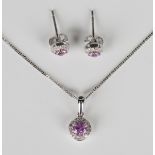 A white gold, pink sapphire and diamond cluster pendant, detailed '375', length 1.4cm, on a 9ct