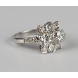 A diamond ring of shaped rectangular panel form, claw set with the two principal cushion cut