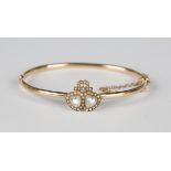 A gold, moonstone and seed pearl oval hinged bangle, the front with two heart shaped motifs and a