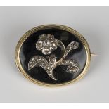 An early Victorian rose cut diamond oval mourning brooch, circa 1850, the centre with an applied