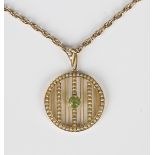 A gold, peridot and seed pearl pendant in a circular banded design, mounted with a circular cut