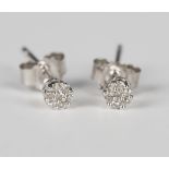 A pair of white gold and diamond seven stone cluster earstuds with post fittings, detailed '375',