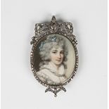 A diamond set oval portrait miniature pendant in the Georgian style, painted with a portrait of a