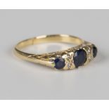 A gold, sapphire and diamond ring, mounted with three cushion cut sapphires and two pairs of small