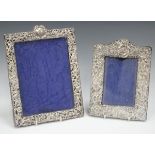 An Edwardian silver mounted rectangular photograph frame, pierced and embossed with putti,