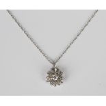 A diamond cluster pendant, mounted with the principal circular cut diamond within a surround of