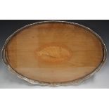 An Edwardian silver mounted mahogany oval gallery tray, the centre inlaid with a shell patera, the