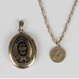 A Victorian black enamelled oval pendant locket, length 4cm, and a charm designed as an imitation