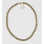 An 18ct gold necklace in a pierced quatrefoil shaped and beaded link design, on a snap clasp, weight