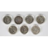 Seven USA silver dollars, comprising five Morgan type, 1881, 1882, 1883, 1884 and 1886, and two