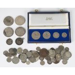 A group of foreign coins, including a Rhodesia four-coin set 1964, cased, two USA Morgan dollars,