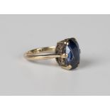 A gold ring, claw set with a cushion cut sapphire, unmarked, weight 3.5g, ring size approx H1/2.