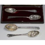 A pair of George III silver Old English pattern tablespoons, each bowl with later embossed