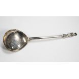 A Continental silver spoon, probably 18th century, the fig shaped bowl back with scroll engraved