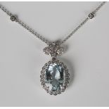 A white gold, aquamarine and diamond pendant necklace, claw set with the large oval cut aquamarine