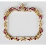 An Asian gold, ruby and cultured pearl frame of shaped rectangular design, decorated with a scroll