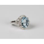 A platinum, aquamarine and diamond ring, claw set with the large oval aquamarine within tapered