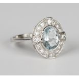An aquamarine and diamond oval cluster ring, collet set with the oval cut aquamarine within a