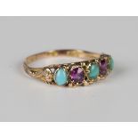 A Victorian 12ct gold, turquoise and garnet three stone ring, mounted with three oval turquoises