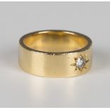 An 18ct gold band ring, star gypsy set with a circular cut diamond, weight 10.5g, ring size approx