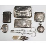 A small collection of silver items, comprising an Edwardian sovereign case with foliate engraved