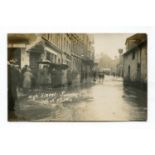 A collection of 14 photographic postcards of floods and snow storms, including postcards titled 'The